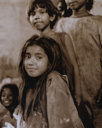 Analogue film photography portrait of a young street girl in Jaipur, India, traditional black and white travel documentary style, by Jeroen Busschers