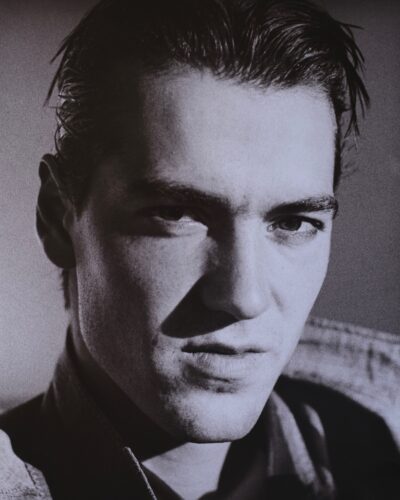 Analogue film photography close-up portrait of a young man, dramatic film noir lighting, expressive black and white studio portraiture, by Jeroen Busschers