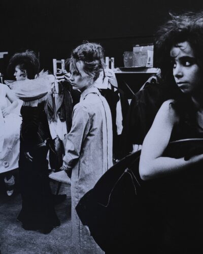 Analogue film photography of the tense atmosphere backatage in a dressing room before a fashion show, documentary black and white style, by Jeroen Busschers